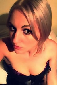 the woman lays on a bed with her pussy filled while giving anal to the guy